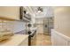 Bright kitchen featuring stainless steel appliances, white cabinetry, quartz countertops and modern lighting fixtures at 445 Matisse S Cir # 445, Nokomis, FL 34275