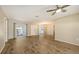 Large living room features modern wood-look floors, sliding glass doors, and an abundance of natural light at 445 Matisse S Cir # 445, Nokomis, FL 34275