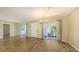 Spacious living room with modern wood-look flooring and large sliding glass doors leading to the outdoors at 445 Matisse S Cir # 445, Nokomis, FL 34275