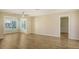 Open-concept living room features modern wood floors, neutral paint, and lots of natural light at 445 Matisse S Cir # 445, Nokomis, FL 34275