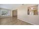 Open living space with wood-look floors and a pass-through window to the kitchen and open floor plan at 445 Matisse S Cir # 445, Nokomis, FL 34275