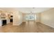 Bright living room with modern wood floors, neutral paint, open to kitchen and dining areas at 445 Matisse S Cir # 445, Nokomis, FL 34275