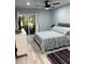 Bedroom with neutral walls, ceiling fan, and sliding glass doors to screened lanai at 4511 3Rd Street W Cir # 289, Bradenton, FL 34207