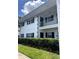Two-story condo with white walls, black shutters, and a well-maintained hedge in front at 4511 3Rd Street W Cir # 289, Bradenton, FL 34207
