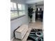 Hallway with wood floors, beach-themed bench, palm tree and view of the kitchen at 4511 3Rd Street W Cir # 289, Bradenton, FL 34207