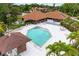 Aerial view of community pool and clubhouse surrounded by lush landscaping at 4644 Red Maple Rd # 1303, Bradenton, FL 34210