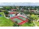 Aerial view of community tennis courts, pool and lush landscaping at 4644 Red Maple Rd # 1303, Bradenton, FL 34210