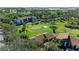 Beautiful aerial view of lush golf course, tropical trees and well-maintained landscaping at 4644 Red Maple Rd # 1303, Bradenton, FL 34210