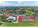 Aerial view of community tennis courts, pool, mature trees and well maintained landscaping at 4644 Red Maple Rd # 1303, Bradenton, FL 34210