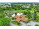 Aerial view of community clubhouse, tennis courts, and pool surrounded by lush landscaping at 4644 Red Maple Rd # 1303, Bradenton, FL 34210