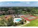 Aerial view of community featuring pool, tennis courts, and residential buildings at 4644 Red Maple Rd # 1303, Bradenton, FL 34210