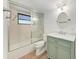 Bathroom features a green vanity and a bathtub with a sliding glass door at 4644 Red Maple Rd # 1303, Bradenton, FL 34210