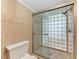 Modern bathroom featuring a tiled shower with glass block and a sleek glass door at 4644 Red Maple Rd # 1303, Bradenton, FL 34210