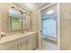 Bathroom featuring a vanity, walk-in shower, and ceramic tile throughout the room at 4644 Red Maple Rd # 1303, Bradenton, FL 34210