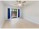 Bedroom with neutral paint, light wood floor, and an outdoor view through a sliding glass door at 4644 Red Maple Rd # 1303, Bradenton, FL 34210