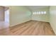 Cozy bedroom featuring wood floors, bright green walls and a large window providing natural light at 4644 Red Maple Rd # 1303, Bradenton, FL 34210
