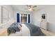Stylized bedroom with blue bedding, curtains, and sliding glass door to outdoor space at 4644 Red Maple Rd # 1303, Bradenton, FL 34210