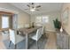 Bright dining room featuring wood floors, a ceiling fan, and a window with views of the outdoors at 4644 Red Maple Rd # 1303, Bradenton, FL 34210
