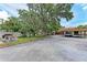 Home with a large driveway, carport, picnic table and mature landscaping at 4644 Red Maple Rd # 1303, Bradenton, FL 34210