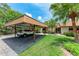 Home featuring a covered carport and tropical landscaping, offering shade and curb appeal at 4644 Red Maple Rd # 1303, Bradenton, FL 34210