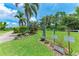 Community golf course entrance lined with mature palm trees and beautiful landscaping at 4644 Red Maple Rd # 1303, Bradenton, FL 34210