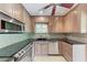 Kitchen featuring stainless steel appliances, backsplash, tile countertops and light brown wooden cabinets at 4644 Red Maple Rd # 1303, Bradenton, FL 34210