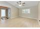 Inviting living room with wood floors, large window with plantation shutters, and neutral wall color at 4644 Red Maple Rd # 1303, Bradenton, FL 34210