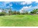 Beautifully manicured putting green surrounded by lush greenery and blue skies at 4644 Red Maple Rd # 1303, Bradenton, FL 34210