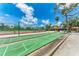 Shuffleboard courts with tennis court and shaded seating area at 4644 Red Maple Rd # 1303, Bradenton, FL 34210