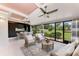Relaxing sunroom featuring lots of natural light, patio seating, and views of the outdoor garden at 4644 Red Maple Rd # 1303, Bradenton, FL 34210