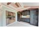Sunroom featuring dark brown wooden cabinets and partial view of the kitchen at 4644 Red Maple Rd # 1303, Bradenton, FL 34210