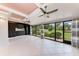 Bright sunroom featuring white tile floors, black cabinets, multiple ceiling fans and windows at 4644 Red Maple Rd # 1303, Bradenton, FL 34210