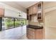 Bright sunroom featuring white tile floors, partial cabinets, multiple ceiling fans and view to the backyard at 4644 Red Maple Rd # 1303, Bradenton, FL 34210