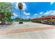 Scenic view of a tennis court and golf cart parking area with blue skies overhead at 4644 Red Maple Rd # 1303, Bradenton, FL 34210