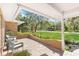 Charming outdoor patio overlooking a well-manicured lawn and lush landscaping at 4928 Hidden Oaks Trl, Sarasota, FL 34232