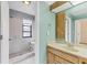Bright bathroom with a white tiled shower and a wooden vanity at 5273 Myrtle Wood # 37, Sarasota, FL 34235