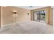 Neutral bedroom with wall sconces and sliding glass doors to the outside patio at 5273 Myrtle Wood # 37, Sarasota, FL 34235