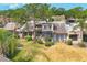 Two-story townhouse with a well-kept lawn and mature landscaping in a residential neighborhood at 5273 Myrtle Wood # 37, Sarasota, FL 34235