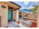 Townhouse with a unique courtyard area that features a table, umbrella, and turquoise front door at 5273 Myrtle Wood # 37, Sarasota, FL 34235