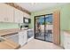 A cozy kitchen with white cabinets and sliding door to the outdoor patio at 5273 Myrtle Wood # 37, Sarasota, FL 34235