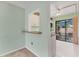 View into the kitchen, featuring white cabinets, a breakfast bar, and an adjacent outdoor seating area at 5273 Myrtle Wood # 37, Sarasota, FL 34235