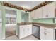 Kitchen with white cabinetry overlooking an adjacent living area at 5273 Myrtle Wood # 37, Sarasota, FL 34235