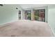 Spacious living room with vaulted ceilings, large windows, and sliding doors to the patio at 5273 Myrtle Wood # 37, Sarasota, FL 34235