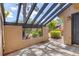 Private patio with stone pavers and a decorative screen wall at 5273 Myrtle Wood # 37, Sarasota, FL 34235