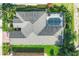 Aerial view of a home with a screened-in pool and lush landscaping at 5320 Layton Dr, Venice, FL 34293
