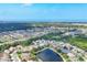 Aerial view of a community with ponds and mature landscaping near the ocean at 5320 Layton Dr, Venice, FL 34293