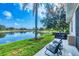 Backyard features a tranquil lake view, a hot tub, and comfortable outdoor seating at 5320 Layton Dr, Venice, FL 34293