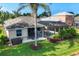 A well-manicured backyard featuring a spa, patio, and screened-in pool at 5320 Layton Dr, Venice, FL 34293