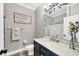Well-lit bathroom with a modern vanity, framed mirror, and a glass-enclosed shower at 5320 Layton Dr, Venice, FL 34293
