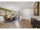 Elegant dining area with wood floors, decorative pillars, chandelier, and stylish decor at 5320 Layton Dr, Venice, FL 34293